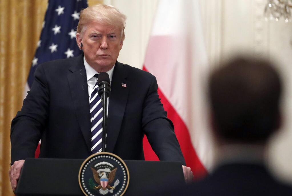 President Donald Trump listens to a reporter's question during a news conference with Polish President Andrzej Duda, in the East Room of the White House, Tuesday, Sept. 18, 2018, in Washington. (AP Photo/Alex Brandon)