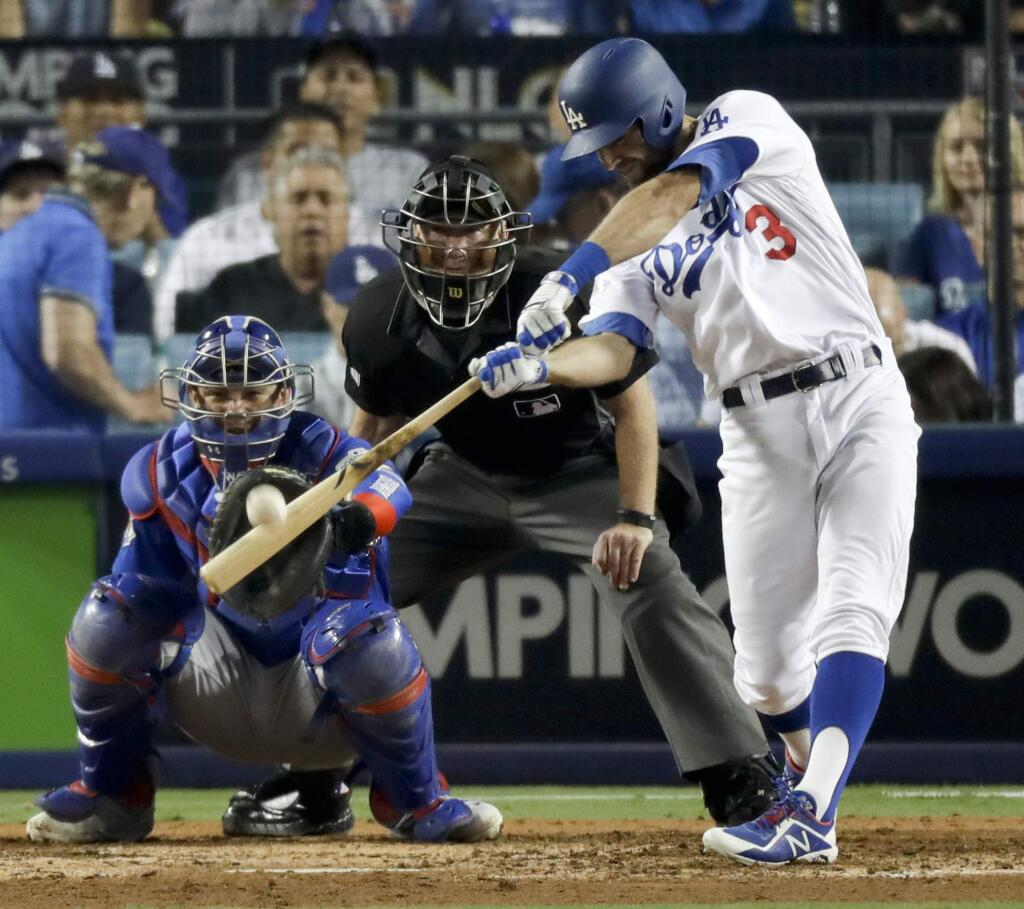 The Los Angeles Dodgers' Chris Taylor hits a home run against the Chicago Cubs during the sixth inning of Game 1 of the National League Championship Series in Los Angeles, Saturday, Oct. 14, 2017. (AP Photo/Alex Gallardo)