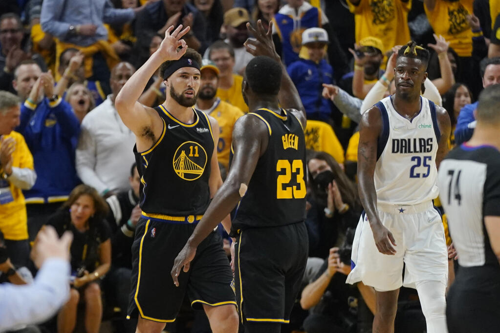 Warriors guard Klay Thompson celebrates his basket with forward Draymond Green during the first half in Game 5 of the Western Conference Finals in San Francisco on Thursday, May 26, 2022. (Jeff Chiu / ASSOCIATED PRESS)