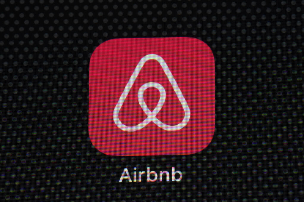 FILE - The Airbnb app icon is displayed on an iPad screen in Washington, D.C., on May 8, 2021. Airbnb has reported its second-straight quarterly profit and it says its revenue is now higher than it was before the pandemic. Airbnb said Tuesday, Feb. 15, 2022 that it earned $55 million in the fourth quarter. (AP Photo/Patrick Semansky, File)