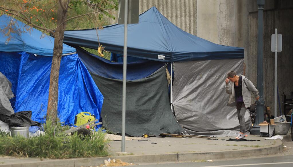 On West Sixth Street, a large homeless encampment has taken root. Individuals are using the underpass, sidewalks, and parking lots to set up their camps, Saturday, April 18, 2020 in Santa Rosa. (Kent Porter / The Press Democrat) 2020