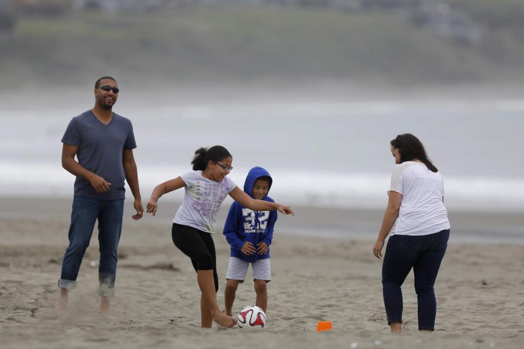 Taylor Cager, 9, ties to score a goal as she plays soccer with her her brother, Sean, 8, father, Brandon, and her mother, Julie, at Doran Regional Park on Monday, March 16, 2015 in Bodega Bay, California . (BETH SCHLANKER/ The Press Democrat)
