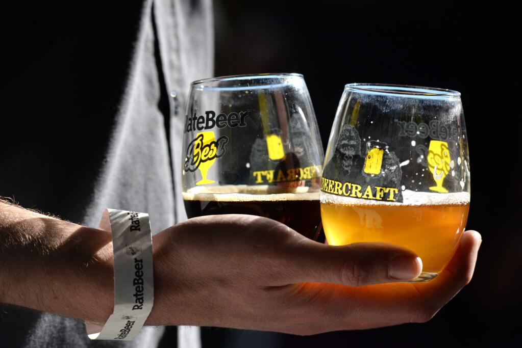 Eric Storz, of Santa Rosa, holding a few samples of beer during the RateBeer Best International Beer Festival held at the Sonoma County airport on Sunday, Jan. 31, 2016. (Erik Castro / for The Press Democrat)