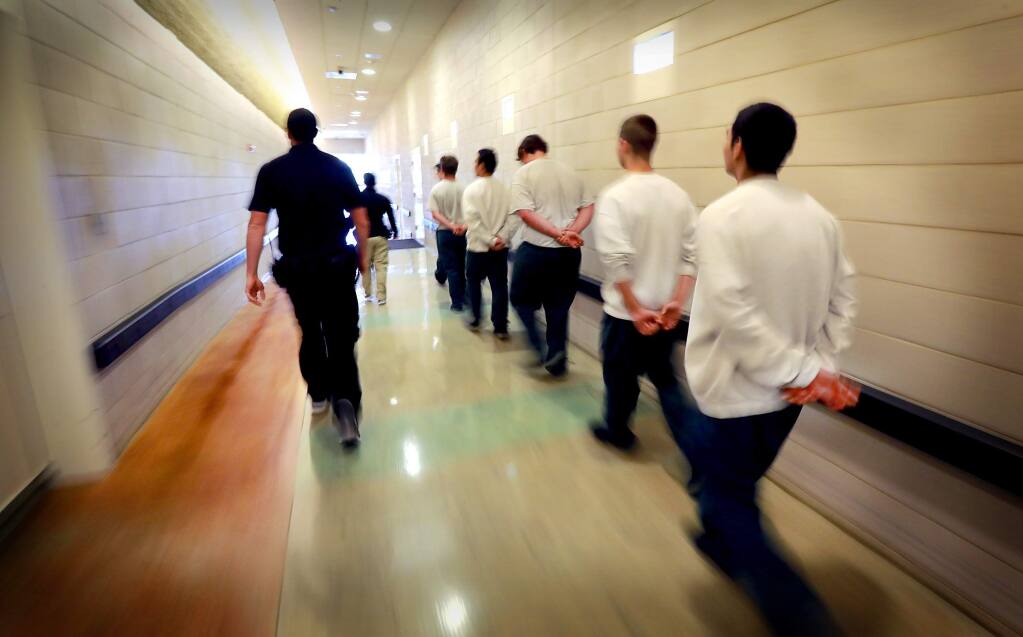 Juvenile Hall guards walk inmates from their unit to a meeting. (JOHN BURGESS / The Press Democrat, 2017)