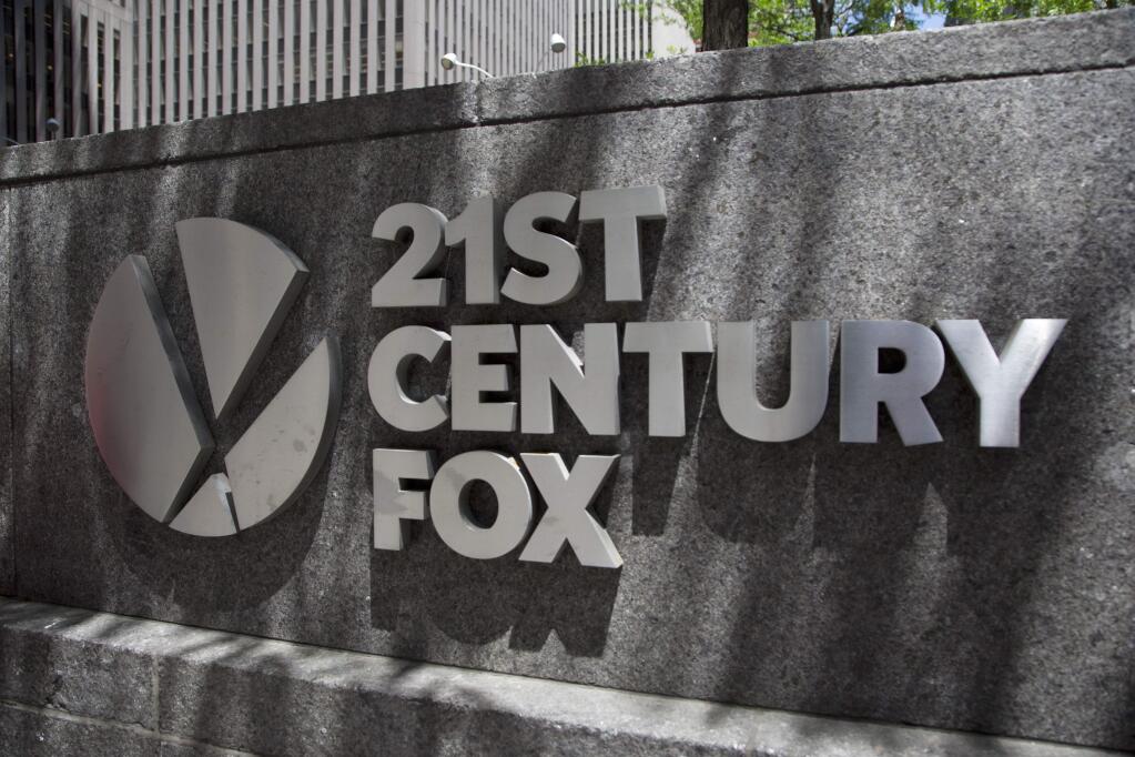 FILE - This June 14, 2018, file photo shows the 21st Century Fox logo outside its New York office. Comcast says it's dropping out of the bidding war for Twenty-First Century Fox's entertainment business, instead focusing on its bid for Sky.(AP Photo/Mark Lennihan, File)