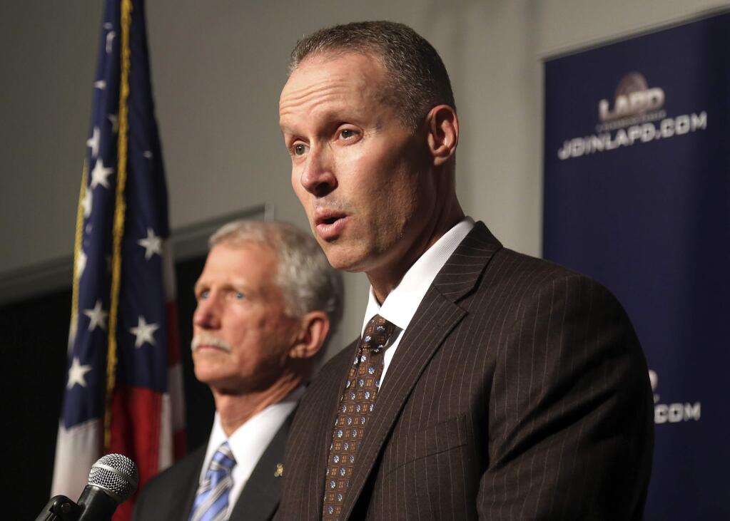 Justin Eisenberg, the chief of detectives for the Los Angeles Police Department, right, speaks at a news conference in Los Angeles at police headquarters alongside Capt. William Hays, Tuesday, Feb. 6, 2018. A California man has been charged with murder and arson after killing his victim, dismembering the body and carrying it aboard a train in a suitcase before burning the remains. (AP Photo/Mike Balsamo)
