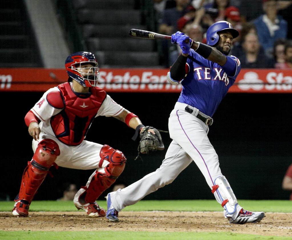 The Texas Rangers' Jurickson Profar watches his two-run home run against the Los Angeles Angels during the sixth inning in Anaheim, Monday, Sept. 24, 2018. (AP Photo/Chris Carlson)