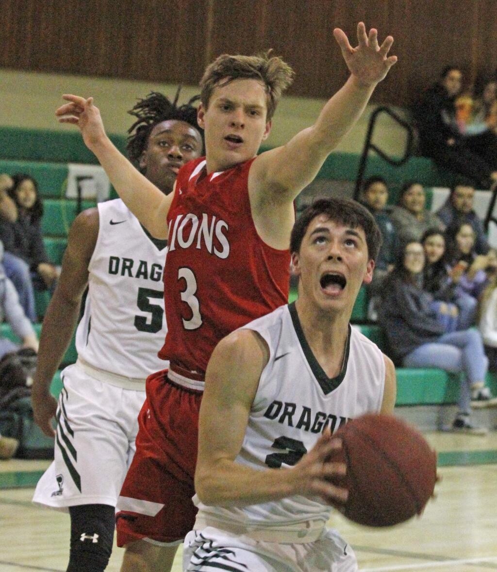 Bill Hoban/Index-TribuneWith Jay Taylor (5) trailing, Sonoma's Dylan Samaniego looks to put a shot over an El Molino defender during Tuesday night's game. The Dragons walked away with a 62-32 throttling of the Lions.