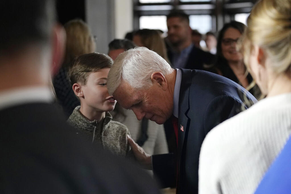 Former Vice President Mike Pence, middle right, talks with a young supporter after speaking about his beliefs on parenting rights, Wednesday, Feb. 15, 2023, in Minneapolis. (AP Photo/Abbie Parr)