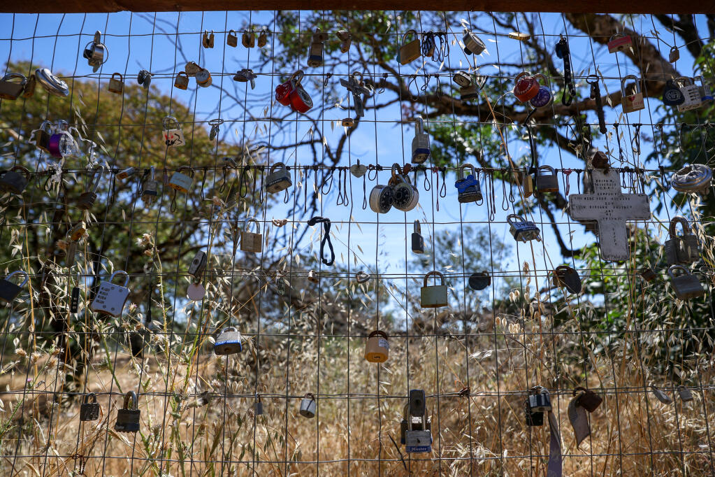 Locks attached to a section of fence at the top of the Alta Vista Trail in Foothill Regional Park memorialize pets and dearly departed in Windsor on Thursday, June 9, 2022.  (Christopher Chung/The Press Democrat)