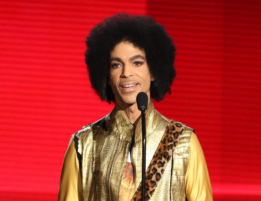 FILE - In this Nov. 22, 2015 file photo, Prince presents the award for favorite album - soul/R&B at the American Music Awards in Los Angeles. (Photo by Matt Sayles/Invision/AP, File)
