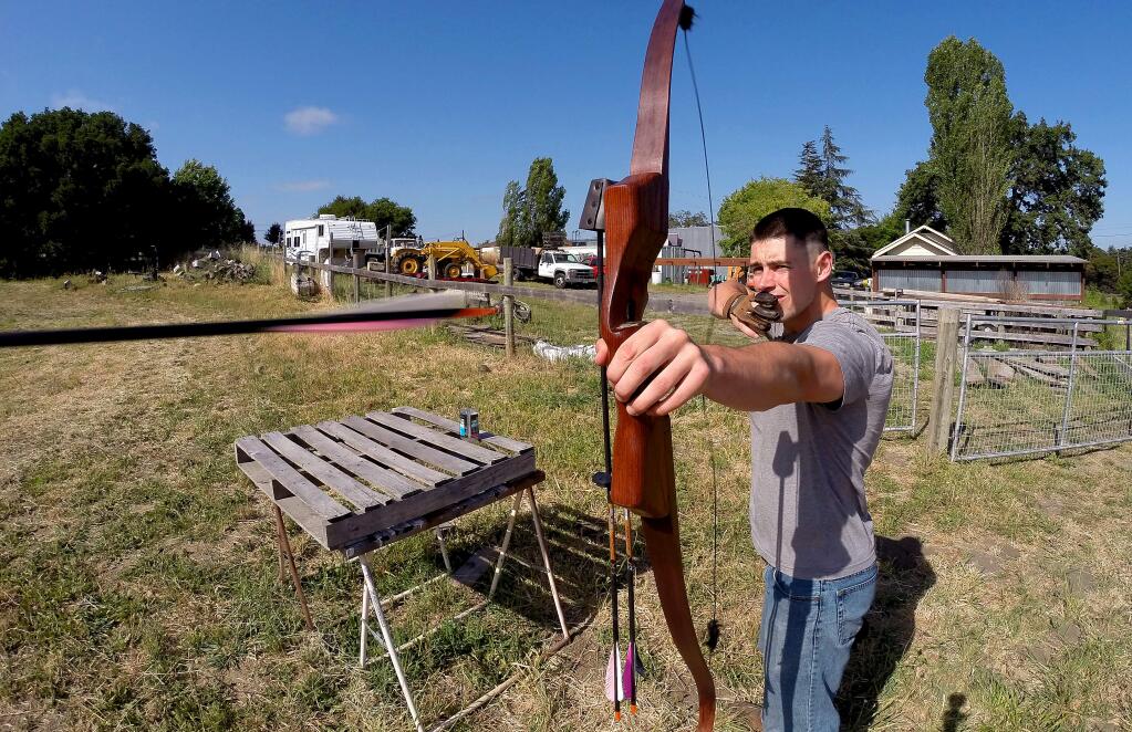 Zach Truskolaski lets an arrow fly as he practices his marksmanship at a friend's house in Penngrove on Tuesday, June 10, 2014. Truskolaski and other members of the Sonoma State University Archery Club participated in the U.S. Intercollegiate Archery Championship, in Long Beach, last month. (Christopher Chung / The Press Democrat)