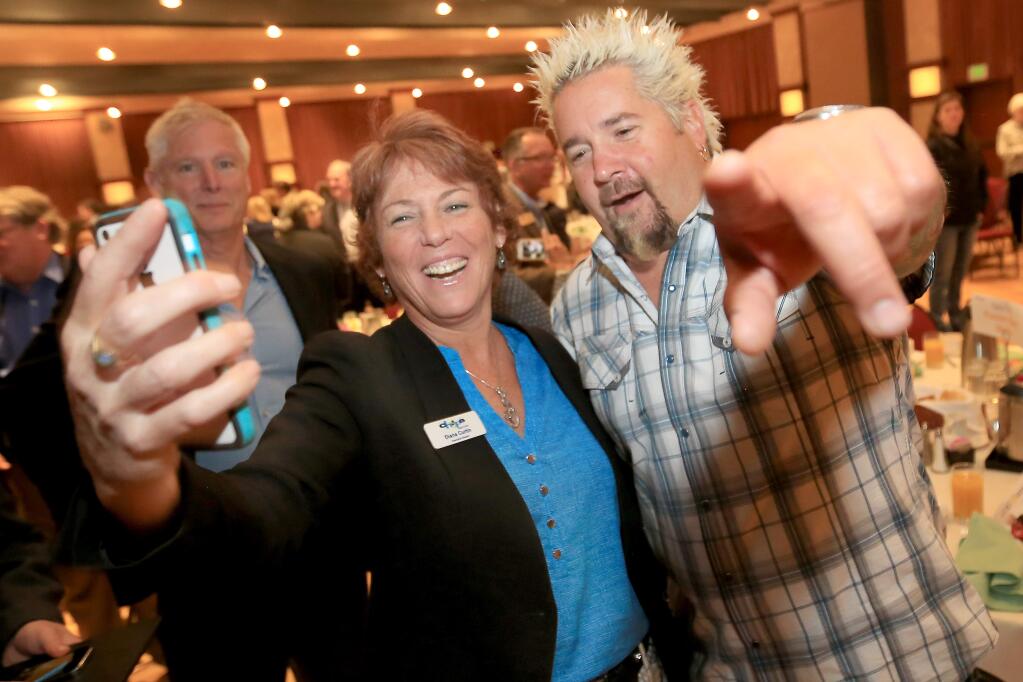 Guy Fieri has his picture taken with Diana Curtin of Chop's Teen Club, Tuesday May 5, 2015 at the Small Business Week breakfast at the Flamingo Hotel in Santa Rosa. (Kent Porter / Press Democrat) 2015