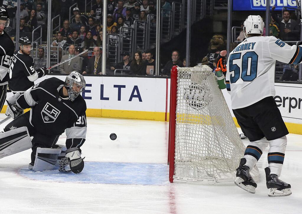 San Jose Sharks enter Chris Tenney (50) scores a goal against Los Angeles Kings goalie Darcy Kuemper (35) in the first period of an NHL hockey game in Los Angeles Monday, Jan. 15, 2018. (AP Photo/Reed Saxon)