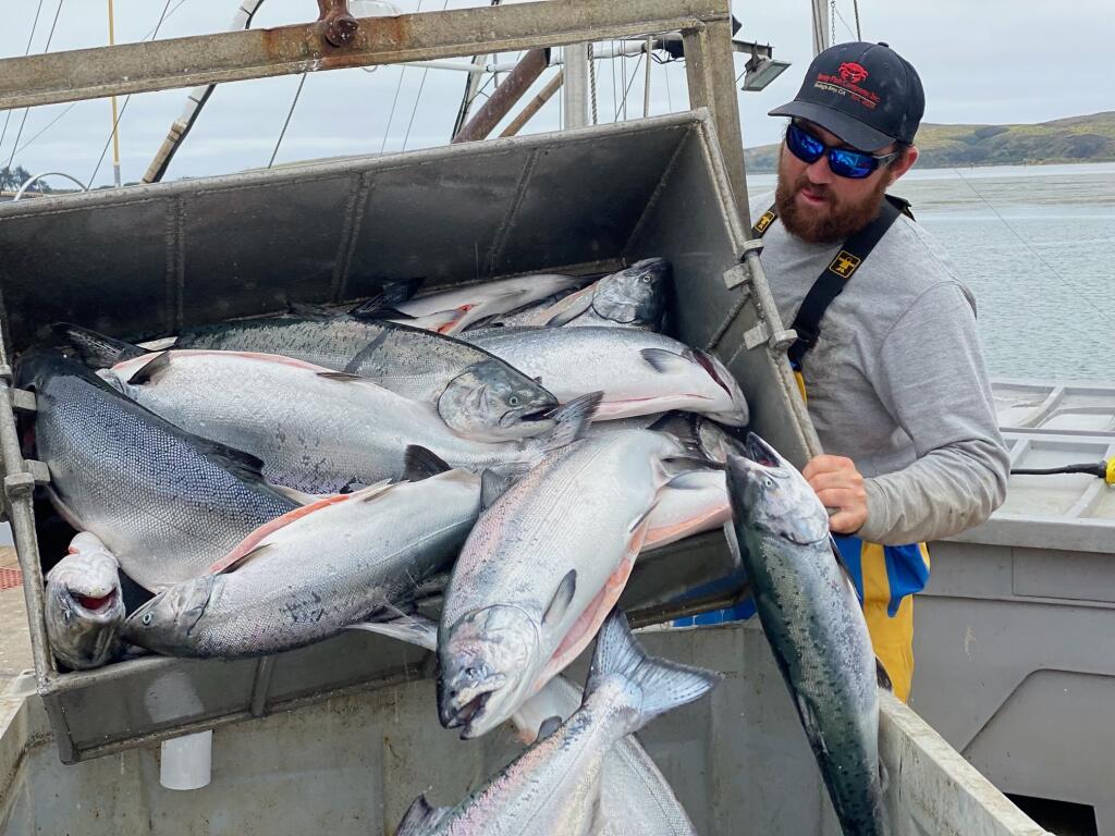 Justin Monckton unloads salmon on the dock for Dandy Fish Co. in June 2022. Photo by Rachel Thomsson