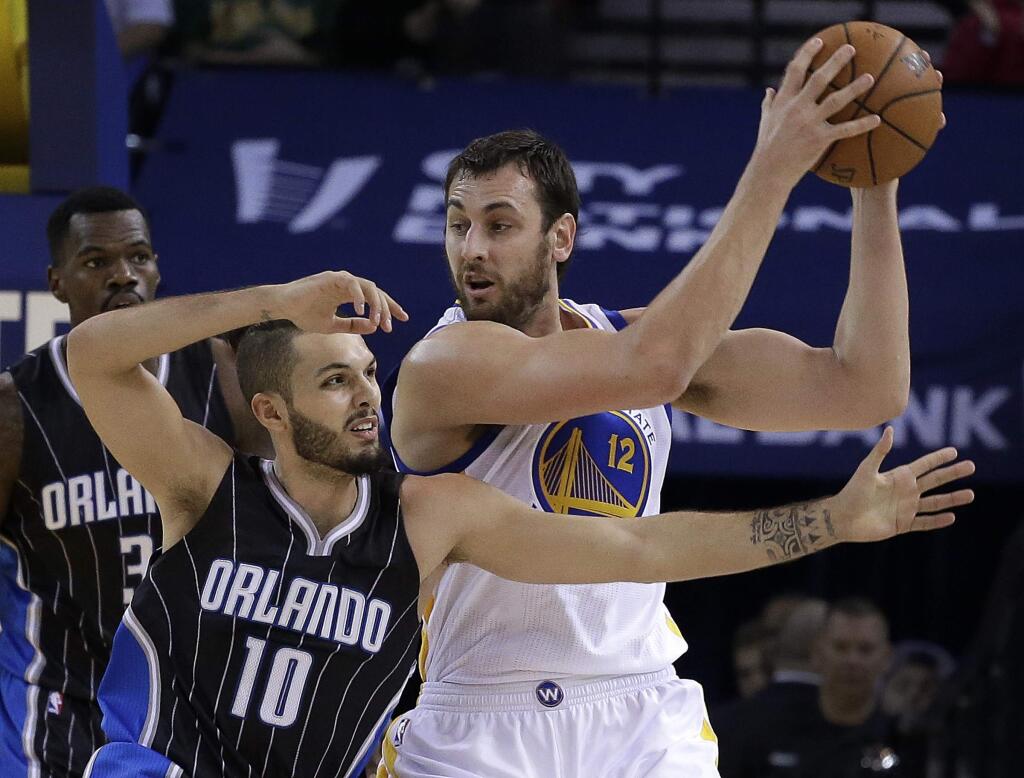 Golden State Warriors' Andrew Bogut, right, keeps the ball from Orlando Magic guard Evan Fournier (10) during the first half of a basketball game Tuesday, Dec. 2, 2014, in Oakland, Calif. (AP Photo/Ben Margot)