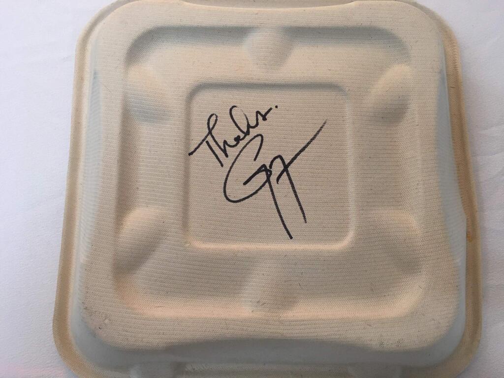 One of the donated plant-based to-go boxes from World Centric that Guy Fieri initialed beneath an expression of gratitude to the Sonoma County health care professionals and first responders he and his team fed in mid-May.