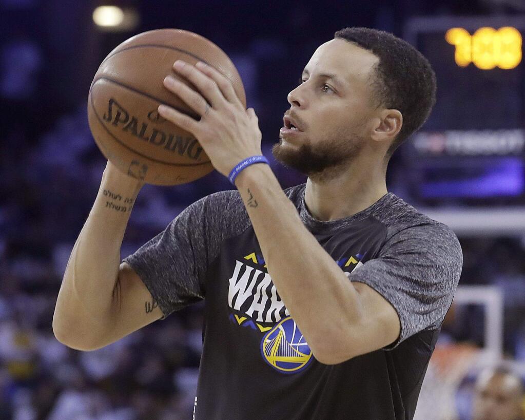 Golden State Warriors guard Stephen Curry before an NBA basketball game against the San Antonio Spurs in Oakland, Calif., Thursday, March 8, 2018. (AP Photo/Jeff Chiu)