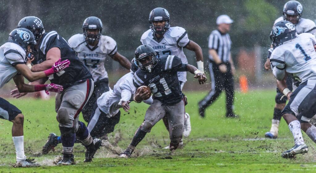 SRJC running back Ja'Narrick James picks his way through the Contra Costa defense and the sloppy conditions of their game on Oct. 15. (Photo by Mark Lilly)
