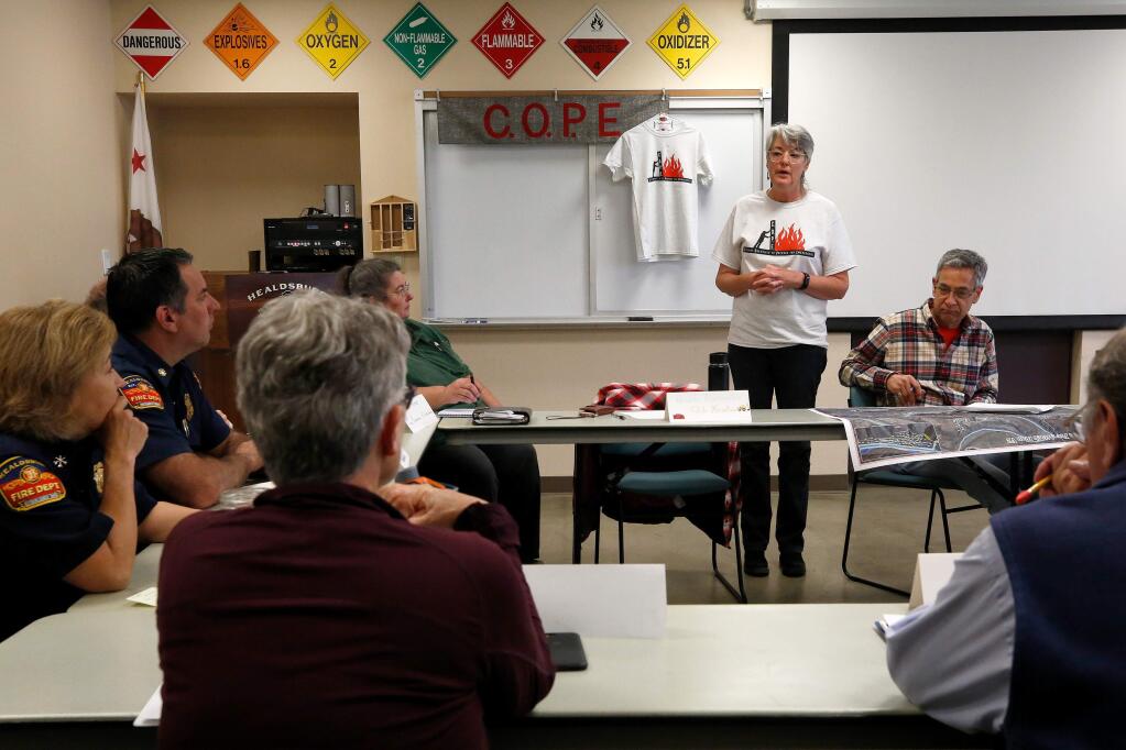 Priscilla Abercrombie, standing, leader of the Fitch Mountain COPE (Citizens Organized to Prepare for Emergencies) speaks during a meeting of north Sonoma County neighborhood emergency preparedness group leaders and fire officials at Healdsburg Fire Station, in Healdsburg, California, on Tuesday, May 14, 2019. (Alvin Jornada / The Press Democrat)