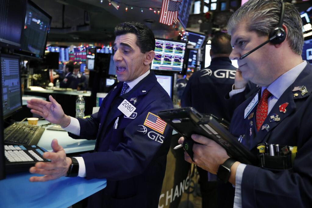 Specialist Peter Mazza, left, and trader John Panin work on the floor of the New York Stock Exchange, Thursday, Dec. 6, 2018. U.S. stocks tumbled in early trading Thursday following a sell-off in overseas markets. (AP Photo/Richard Drew)