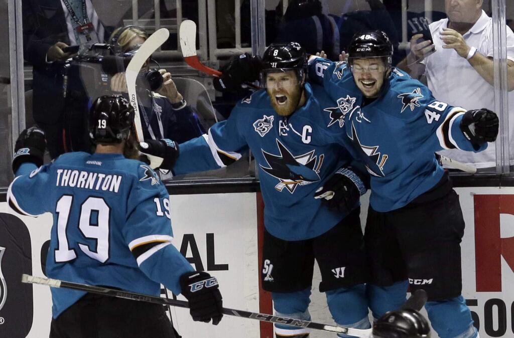 San Jose Sharks' Joe Pavelski, center, celebrates his goal with teammates Tomas Hertl, right, and Joe Thornton (19) during the first period in Game 6 of the NHL hockey Stanley Cup Western Conference finals against the St. Louis Blues Wednesday, May 25, 2016, in San Jose, Calif. (AP Photo/Jeff Chiu)
