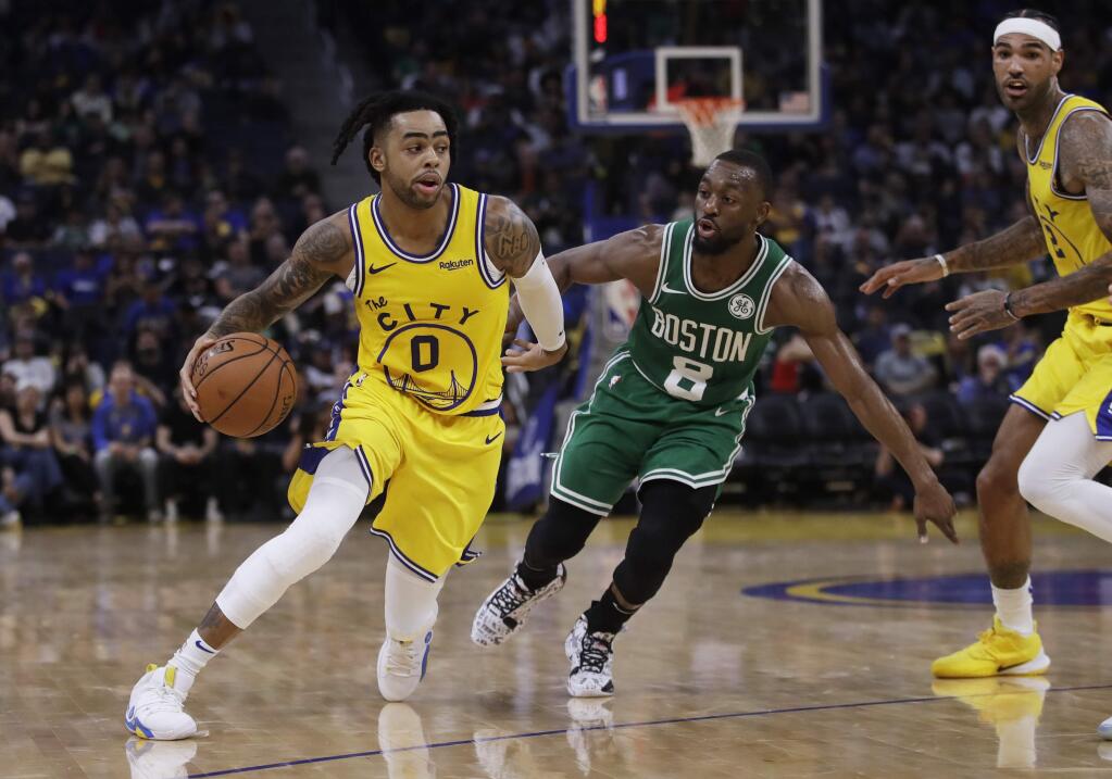 The Golden State Warriors' D'Angelo Russell, left, drives the ball past the Boston Celtics' Kemba Walker during the second half Friday, Nov. 15, 2019, in San Francisco. (AP Photo/Ben Margot)