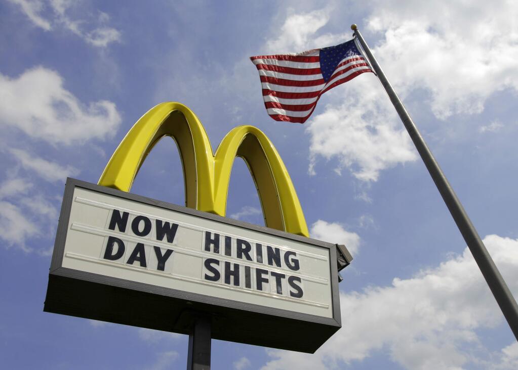 FILE- This May 2, 2012, file photo shows a sign advertising job openings outside a McDonalds restaurant in Chesterland, Ohio. McDonald's on Wednesday, April 1, 2015 said it's raising pay for workers at its company-owned U.S. restaurants, making it the latest employer to sweeten worker incentives in an improving economy. (AP Photo/Amy Sancetta, File)