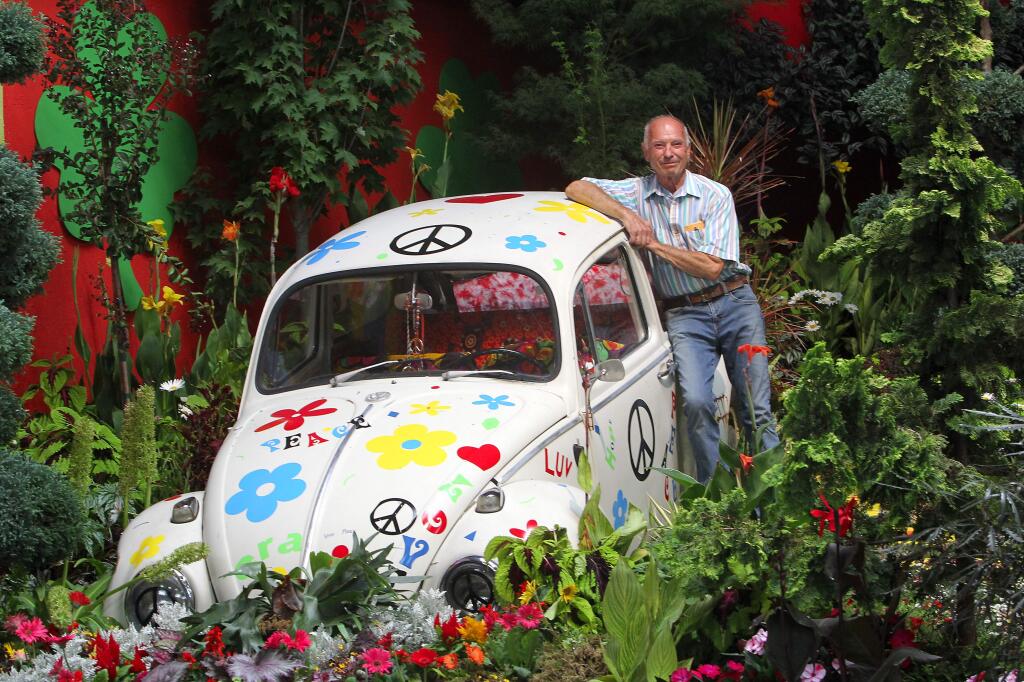 Chet Wilson, the president of the Men's Garden Show of Santa Rosa, with the latest 'Flower Power' exhibit in the Hall of Flowers at the Sonoma County Fair.