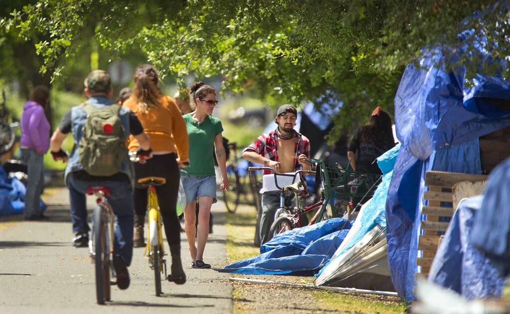 Homeless in a large encampment along the Joe Rodota Trail in Roseland received a 2-day reprieve to evacuate the area by local law enforcement on Friday. (photo by John Burgess/The Press Democrat)