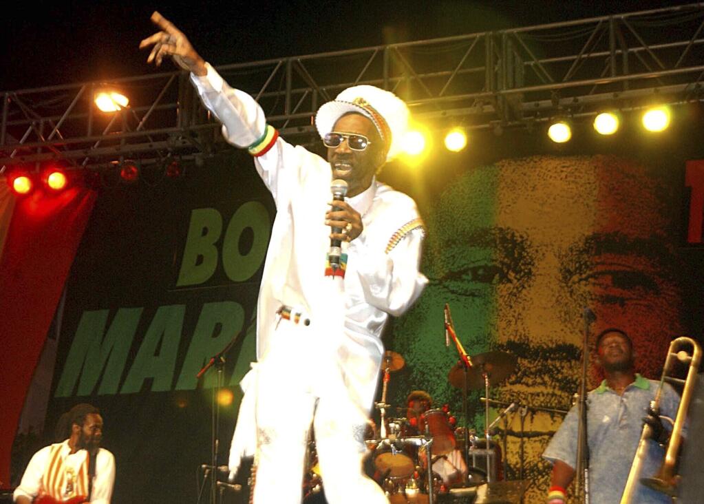 FILE - In this Feb. 6, 2005 file photo, Bunny Wailer performs at the One Love concert to celebrate Bob Marley's 60th birthday, in Kingston, Jamaica.  Wailer, a reggae luminary who was the last surviving original member of the legendary group The Wailers, died on Tuesday, March 2, 2021, in his native Jamaica, according to his manager. He was 73. (AP Photo/Collin Reid, File)