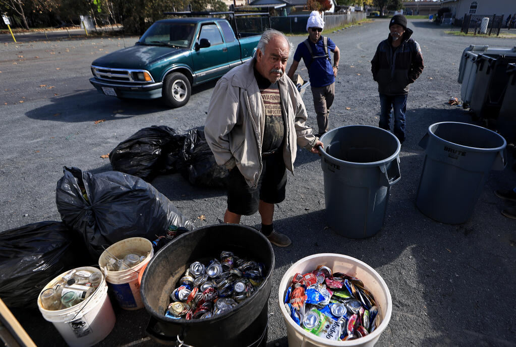 Customers wait to turn in and weigh recyclable plastics, cans and bottles at the Windsor Redemption Center, Tuesday, Nov. 28, 2023. (Kent Porter / The Press Democrat)