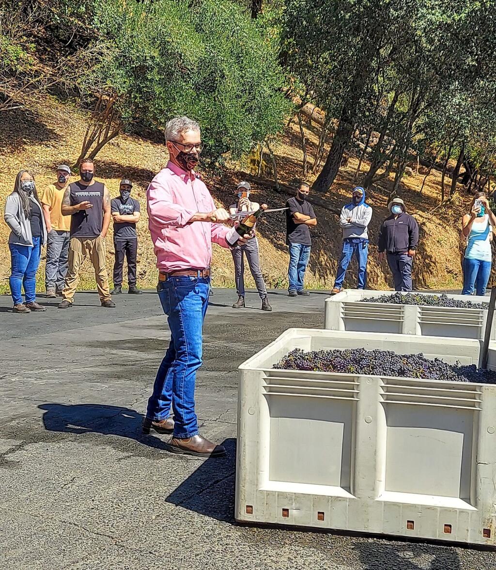 Hugh Davies, proprietor of Schramsberg Vineyards, prepares to christen the first load of 2020 wine grapes at the Calistoga winery on Aug. 5. (Facebook / Schramsberg)