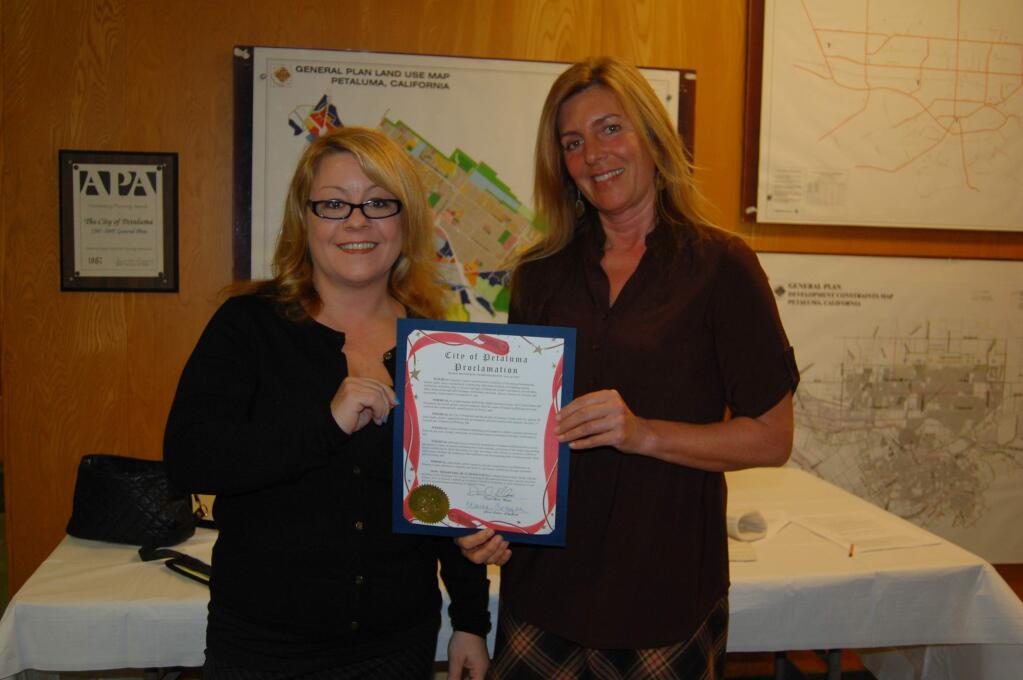 Cindy Rudometkin and Raine Howe of the Polly Klaas Foundation are presented with a proclamation for their work. January 5, 2015.