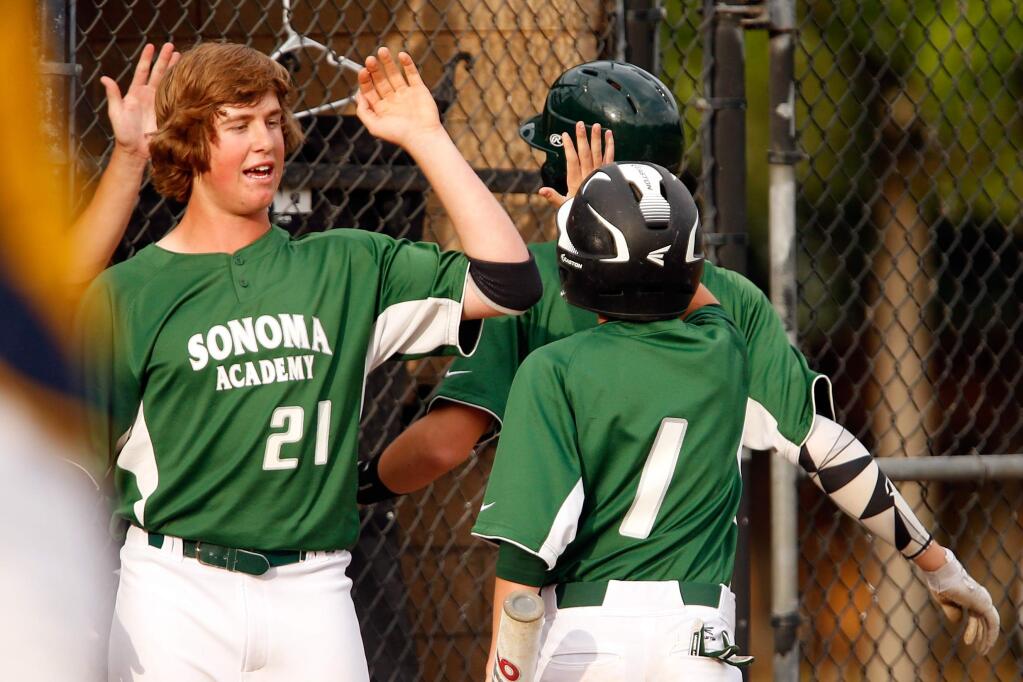 Sonoma Academy's Ethan Jones, left, high-fives Chance Colbert after he scored on a sacrifice fly by Oscar McCauley during a varsity baseball game between Sonoma Academy and Rincon Valley Christian School at Doyle Park in Santa Rosa, California on Tuesday, April 19, 2016. (Alvin Jornada / The Press Democrat)
