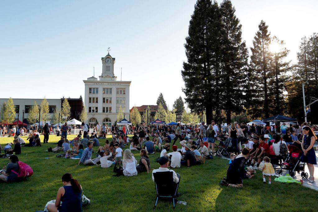 Marketgoers take respite in the shade in the newly reunified Old Courthouse Square during the first Wednesday Night Market of the season, in Santa Rosa, California, on Wednesday, May 3, 2017. (Alvin Jornada / The Press Democrat)