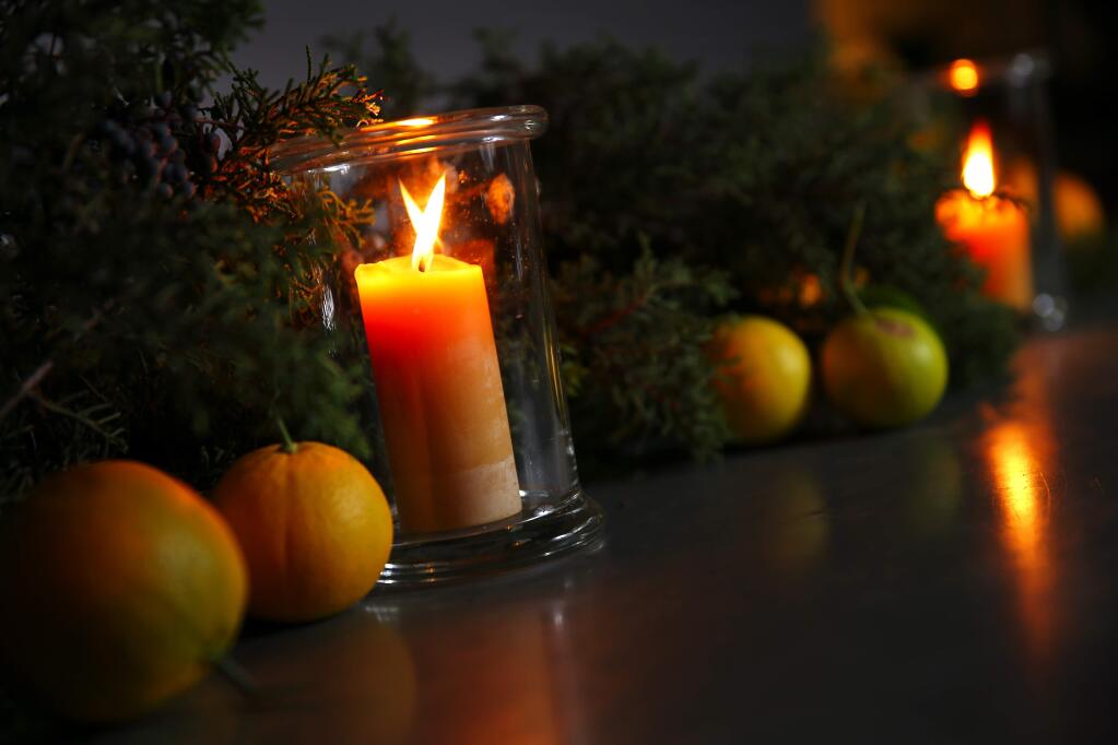A holiday candle arrangement by Dundee Butcher, of Russian River Flower School.(Christopher Chung/ The Press Democrat)