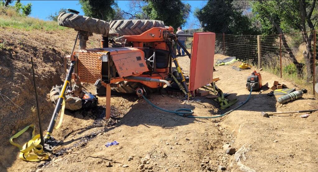 This image shows a tractor that overturned on Nutter Road in Geyserville Friday, May 19, 2023. Its operator suffered a major leg injury, according to the Northern Sonoma County Fire District. (Northern Sonoma County Fire District)