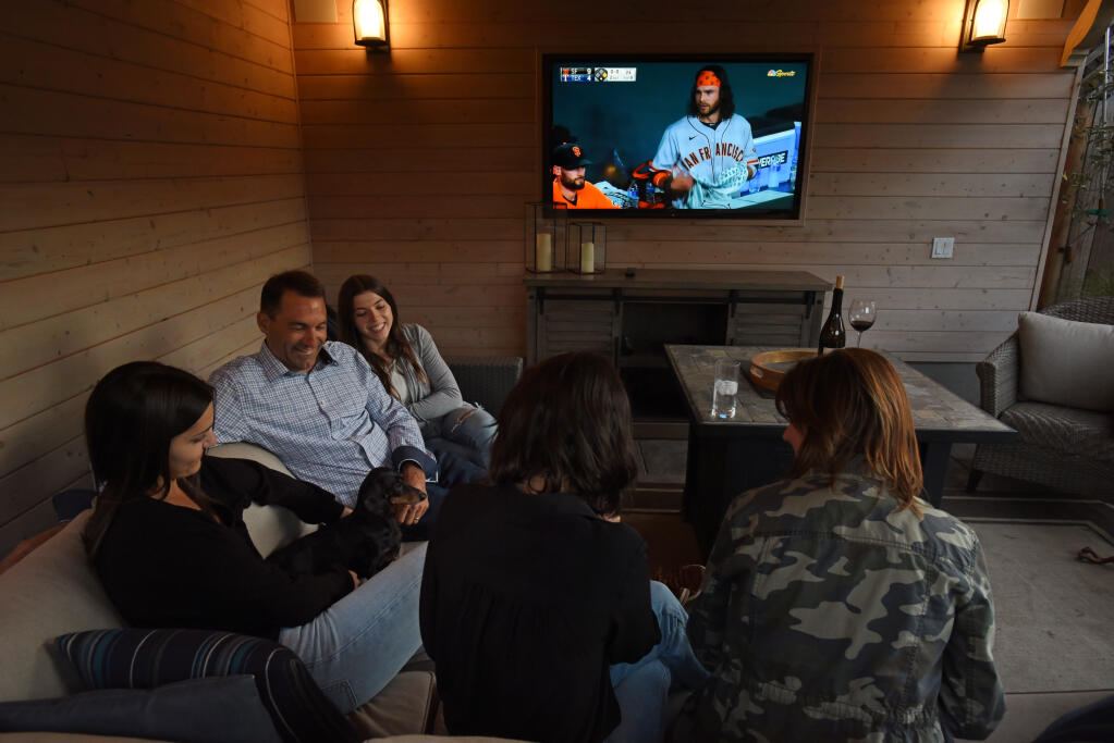 Scott Vice in the outdoor lounge area with his wife Amy, far right, and their daughters, from left, Skylar, 20, Alex, 15, and Jenna, 23, at their home in the Grace Tract neighborhood of Santa Rosa on Tuesday, June 8, 2021. (Erik Castro/for The Press Democrat)