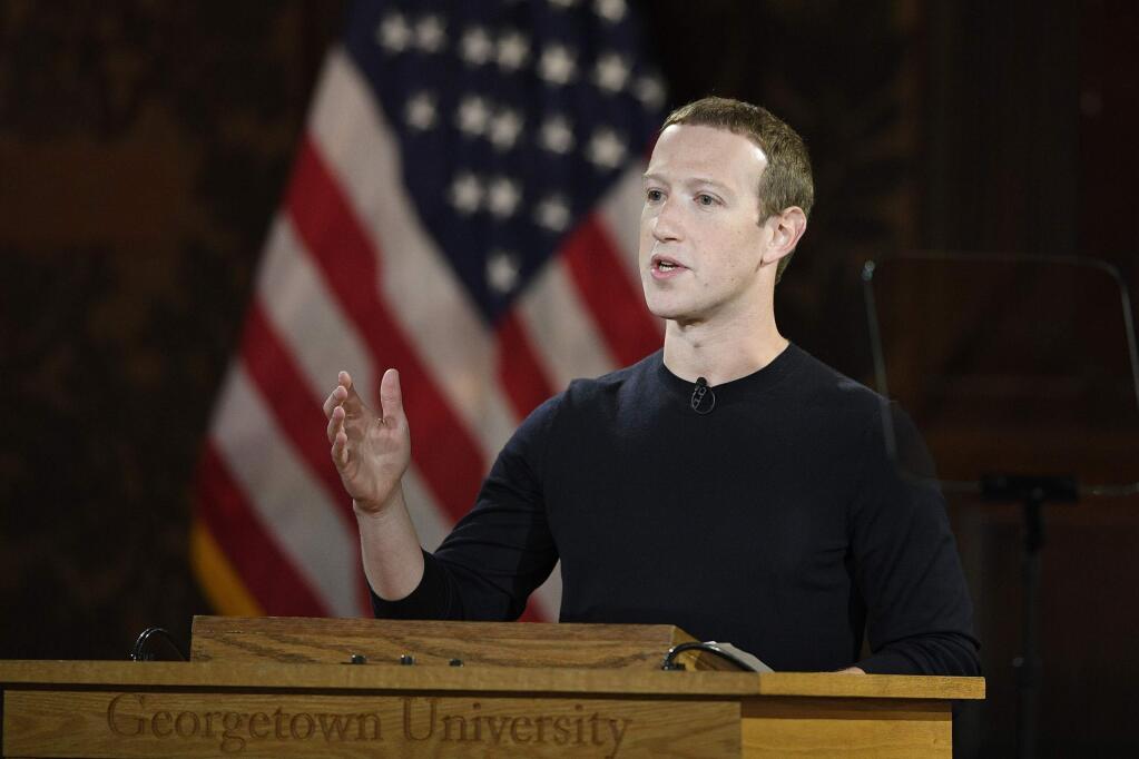 FILE - In this Oct. 17, 2019, file photo Facebook CEO Mark Zuckerberg speaks at Georgetown University in Washington. With just over a year left until the 2020 U.S. presidential election, Facebook is stepping up its efforts to ensure it is not used as a tool to interfere in politics and democracies around the world. Facebook said Monday, Oct. 21, that it will also label state-controlled media as such, label fact -checks more clearly and invest $2 million in media literacy projects. (AP Photo/Nick Wass, File)