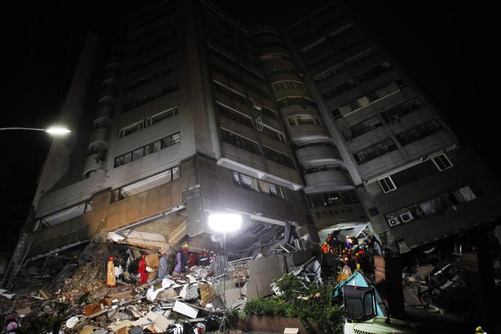 Rescuers work on a search operation at an apartment building collapsed after a strong earthquake in Hualien County, eastern Taiwan, Wednesday, Feb. 7, 2018. A magnitude 6.4 earthquake struck late Tuesday night caused several buildings to cave in and tilt dangerously. (AP Photo/Chiang Ying-ying)