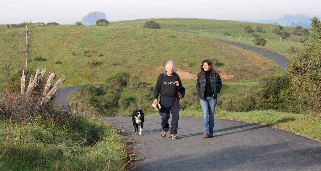 Michael Sunday and Amy Hogan talk as they walk with Michael's boarder collie Shiloh the path above the La Cresta property that they would like to see stay undeveloped on Tuesday, February 3, 2015. (SCOTT MANCHESTER/ARGUS-COURIER STAFF)