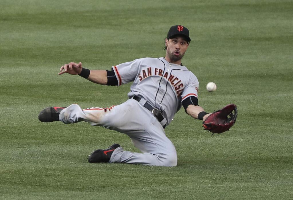 San Francisco Giants left fielder Angel Pagan makes a sliding catch on a ball hit by New York Yankees' Starlin Castro during the eighth inning Saturday, July 23, 2016, in New York. Pagan made the throw to first to catch Brian McCann off the bag for a double play. (AP Photo/Julie Jacobson)