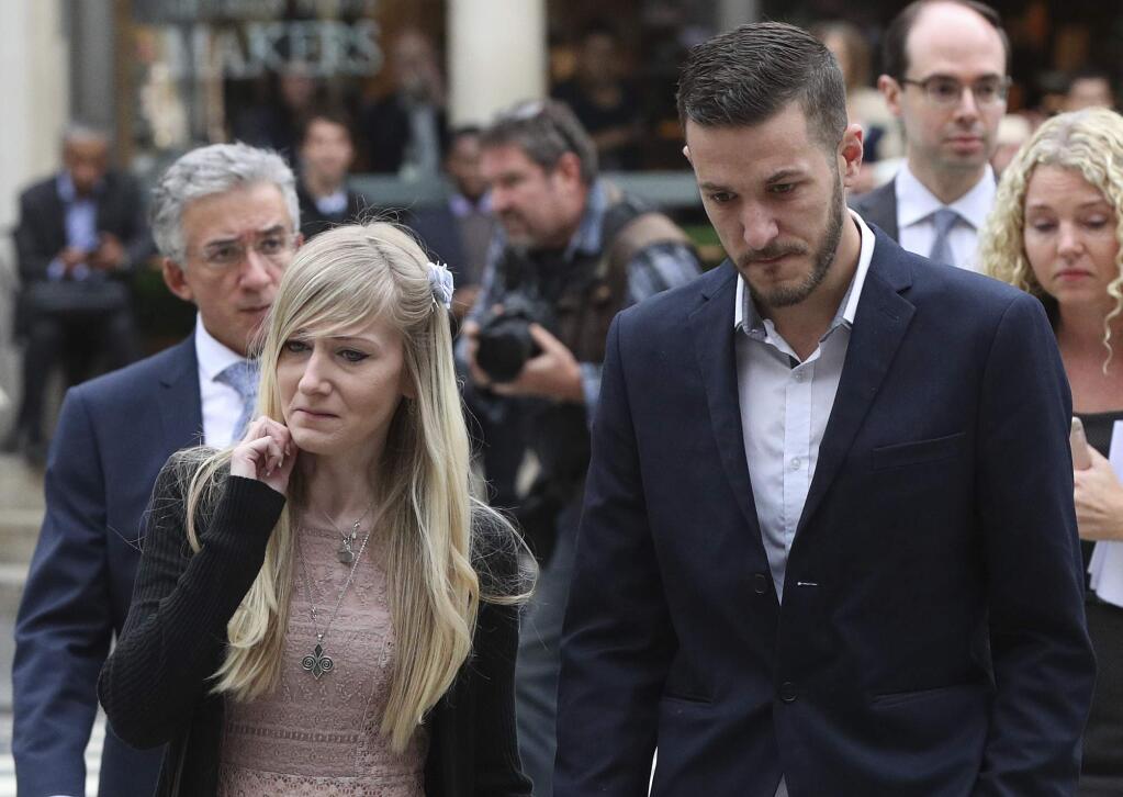 The parents Charlie Gard the critically ill infant Chris Gard and Connie Yates arrive at the Royal Courts of Justice in London ahead of the latest High Court hearing in London Monday July 24, 2017 . They returned to the court for the latest stage in their effort to seek permission to take the child to the United States for medical treatment. Britain's High Court is considering new evidence in the case of Charlie Gard. The 11-month-old has a rare genetic condition, and his parents want to take him to America to receive an experimental treatment.(Jonathan Brady/PA via AP)