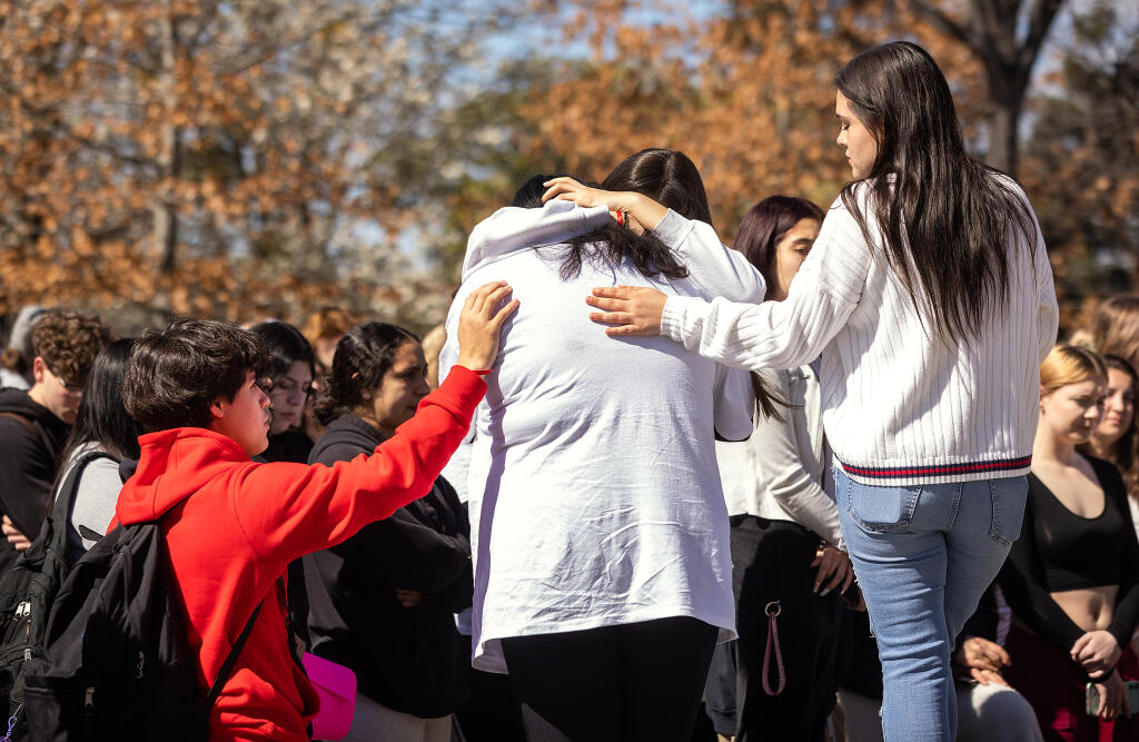 Friends comfort Montgomery student Maleah Chatham after her lunchtime speech about her friend Jayden Pienta, 16, who was killed on campus last week during a fight. The lunchtime rally against school violence included Slater Middle School students who marched from their school, Wednesday, March 8, 2023.  (John Burgess / The Press Democrat)