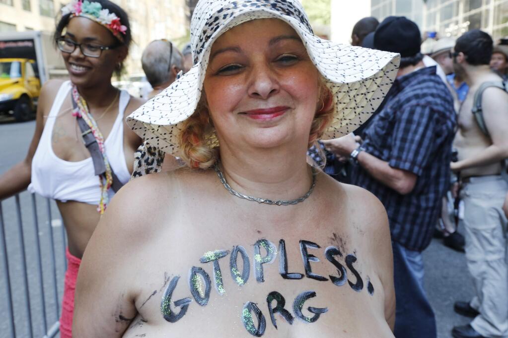 Marisse Caissy, of Montreal participates in the Go Topless Pride Parade, Sunday, Aug. 28, 2016, in New York. Sunday's parade was among dozens of such events celebrating the worldwide Go Topless Day. Appearing bare-breasted has been legal in New York since 1992. (AP Photo/Mark Lennihan)