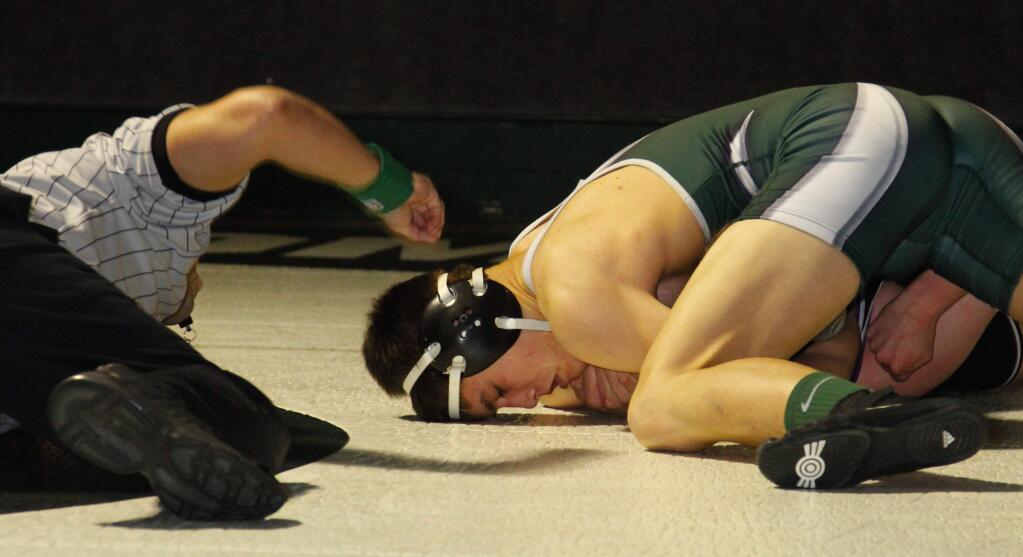 Bill Hoban/Index-TribuneSophomore Noah Bartolome pins his 162-pound opponent in 38 seconds during the Dragons' SCL dual loss to longtime rival Petaluma Wednesday night in Golton Hall. Later in the match, Sonoma junior Dalton Elster turned in a near school-record fastest pin in the heavyweight division.