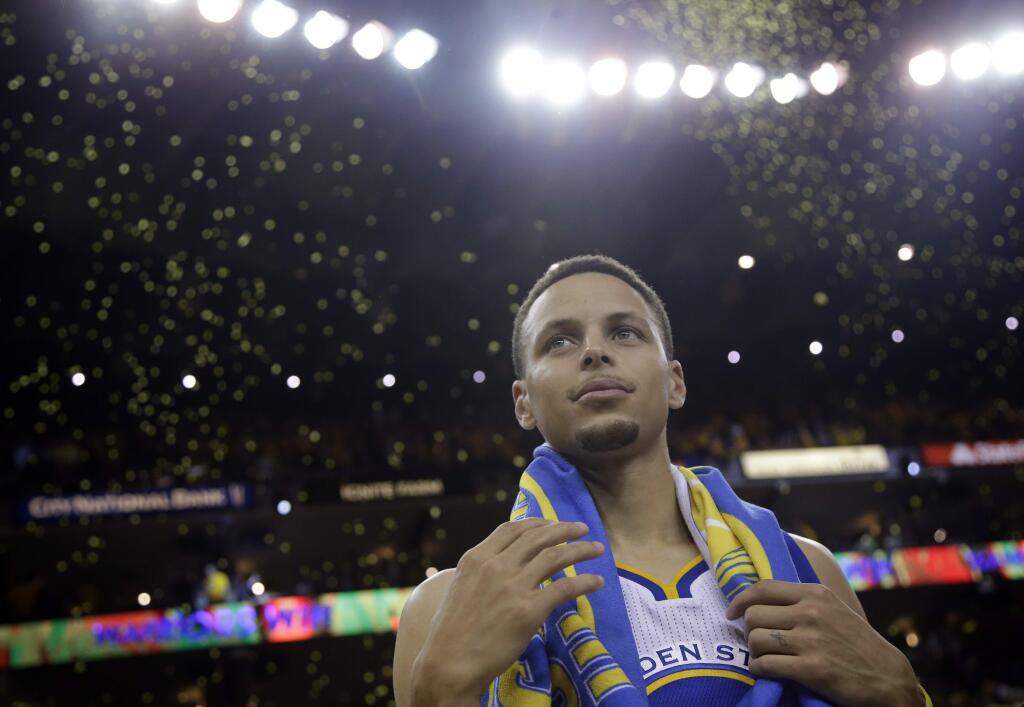 Golden State Warriors' Stephen Curry waits for a interview as confetti comes down after a 118-91 win over the Oklahoma City Thunder in Game 2 of the NBA basketball Western Conference finals Wednesday, May 18, 2016, in Oakland, Calif. (AP Photo/Marcio Jose Sanchez)