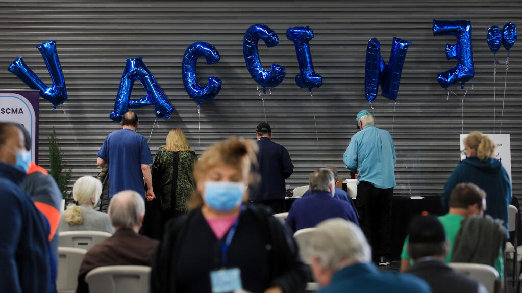 Balloons spelling 'vaccine' decorate the waiting area after  people are vaccinated against COVID-19 at the Sonoma County Medical Association's vaccine clinic at the Sonoma County Fairgrounds, Wednesday, March 3, 2021 in Santa Rosa.  (Kent Porter / The Press Democrat)