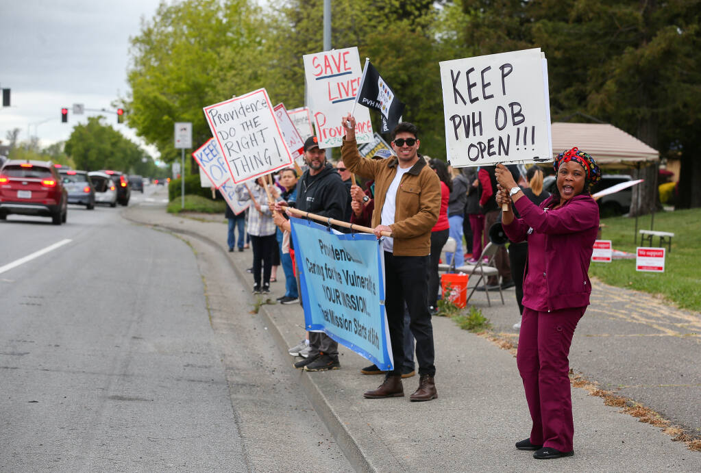 Benita Charles, right, and others protest the planned closure of the birthing center at Petaluma Valley Hospital in Petaluma, Monday, May 1, 2023.  (Christopher Chung /  The Press Democrat)